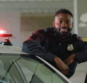 a police officer leaning on a car